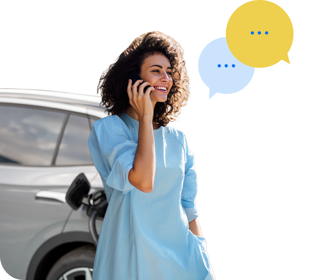 Tüdruk, oma elektriauto vastu nõjatudes, räägib telefoniga.